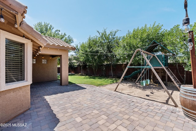 1026 E Madera Estates Ln, Sahuarita, AZ 85629 - fenced backyard with a playground and a patio
