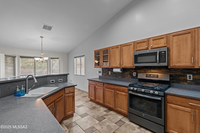 1026 E Madera Estates Ln, Sahuarita, AZ 85629 - kitchen featuring stainless steel appliances, lofted ceiling, backsplash, brown cabinetry, and a chandelier