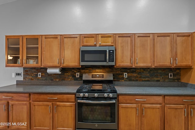 1026 E Madera Estates Ln, Sahuarita, AZ 85629 - kitchen with stainless steel appliances, backsplash, dark countertops, and glass insert cabinets