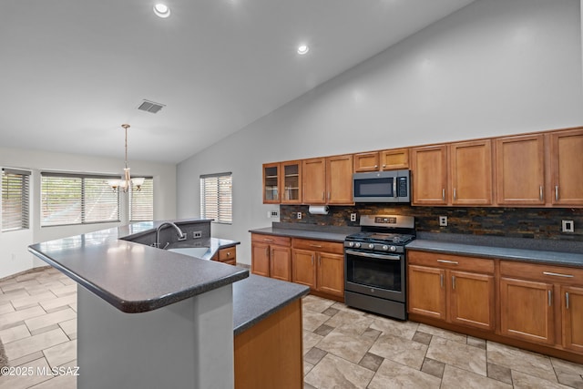 1026 E Madera Estates Ln, Sahuarita, AZ 85629 - kitchen with stainless steel appliances, brown cabinetry, dark countertops, high vaulted ceiling, and recessed lighting