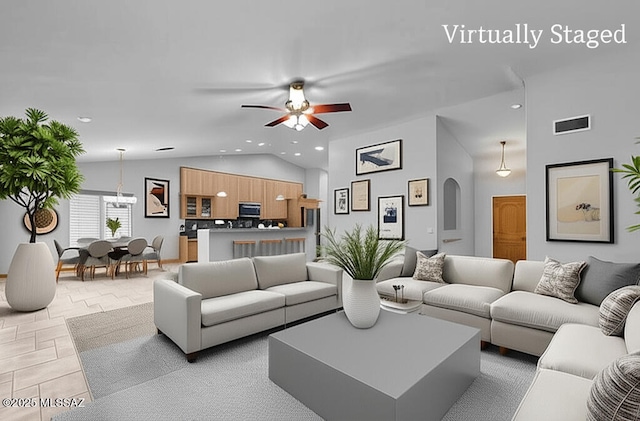 1026 E Madera Estates Ln, Sahuarita, AZ 85629 - living area featuring vaulted ceiling, recessed lighting, a ceiling fan, arched walkways, and a chandelier