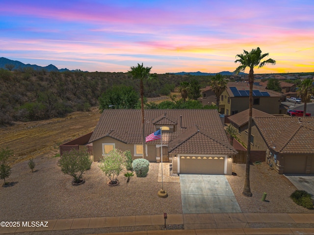 1026 E Madera Estates Ln, Sahuarita, AZ 85629 - view of front of property with a garage, a tiled roof, a mountain view, stucco siding, and driveway