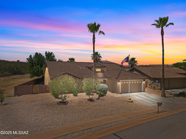 1026 E Madera Estates Ln, Sahuarita, AZ 85629 - view of front of house featuring a tiled roof, driveway, a garage, and stucco siding