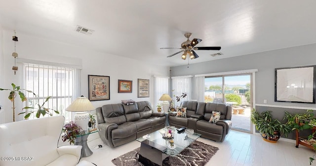15769 S Via Cayetano, Sahuarita, AZ 85629 - living area featuring healthy amount of natural light, ceiling fan, and wood finished floors