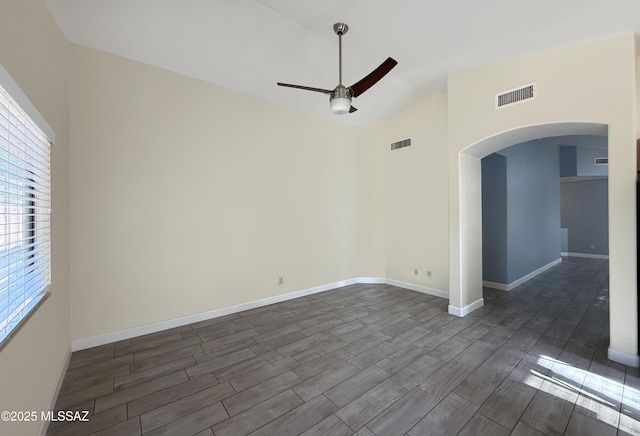 2898 W Simplicity Dr, Tucson, AZ 85741 - empty room with arched walkways, ceiling fan, lofted ceiling, and wood tiled floors