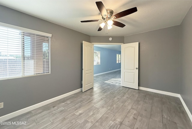 2898 W Simplicity Dr, Tucson, AZ 85741 - spare room featuring a ceiling fan, light wood-type flooring, and a textured ceiling