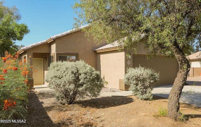 2898 W Simplicity Dr, Tucson, AZ 85741 - view of front facade with stucco siding, an attached garage, concrete driveway, and a tile roof