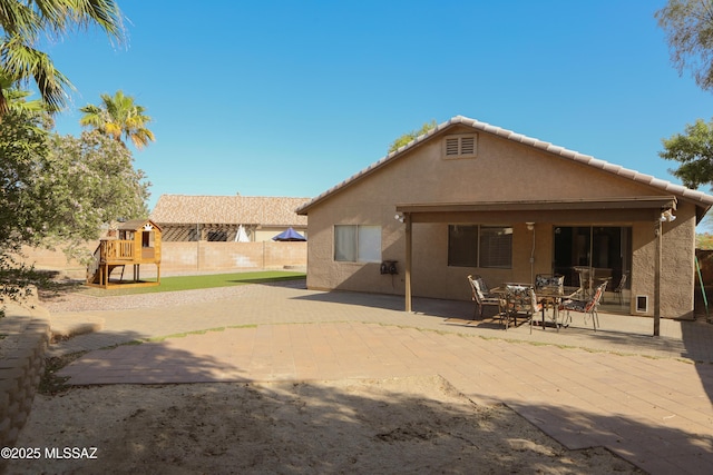 2898 W Simplicity Dr, Tucson, AZ 85741 - back of property featuring a playground, stucco siding, and a patio