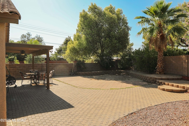 2898 W Simplicity Dr, Tucson, AZ 85741 - fenced backyard featuring a ceiling fan, a patio, and outdoor dining area