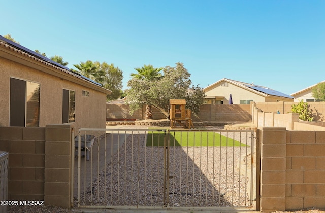 2898 W Simplicity Dr, Tucson, AZ 85741 - fenced yard with a gate and a playground