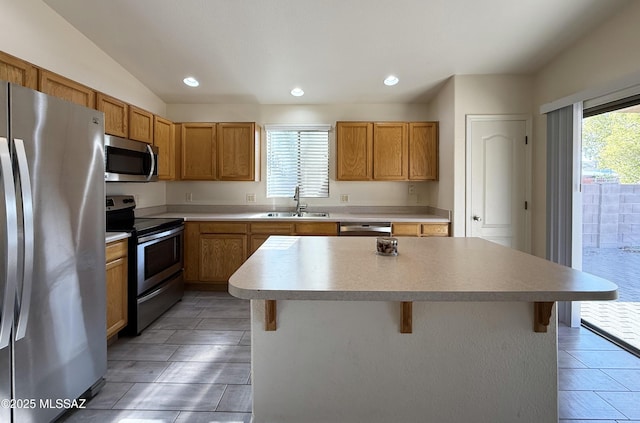 2898 W Simplicity Dr, Tucson, AZ 85741 - kitchen with appliances with stainless steel finishes, a kitchen bar, a kitchen island, recessed lighting, and light countertops