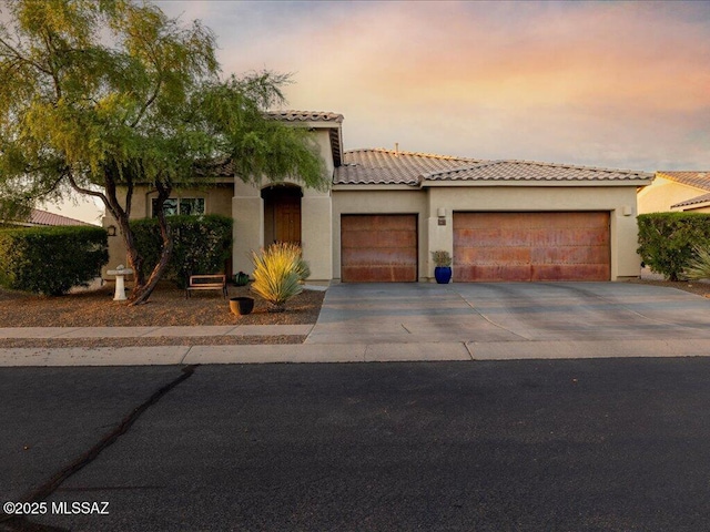 3872 W Sonoma Ranch Pl, Marana, AZ 85658 - mediterranean / spanish home with a garage, driveway, a tile roof, and stucco siding