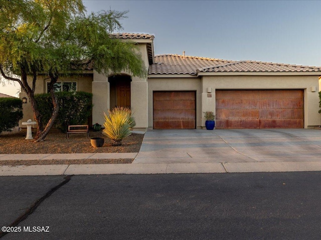 3872 W Sonoma Ranch Pl, Marana, AZ 85658 - mediterranean / spanish home featuring an attached garage, concrete driveway, stucco siding, and a tile roof
