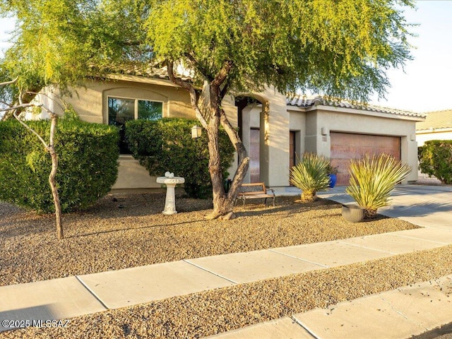 3872 W Sonoma Ranch Pl, Marana, AZ 85658 - view of front of home with stucco siding, an attached garage, concrete driveway, and a tiled roof