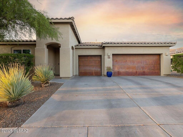 3872 W Sonoma Ranch Pl, Marana, AZ 85658 - mediterranean / spanish-style house with stucco siding, driveway, a garage, and a tiled roof