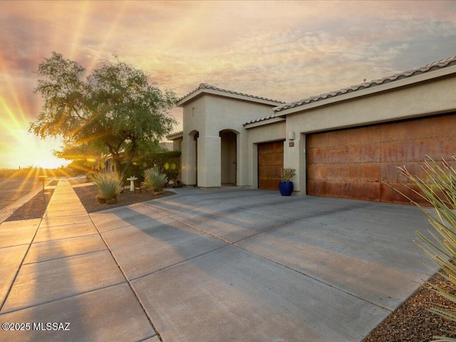 3872 W Sonoma Ranch Pl, Marana, AZ 85658 - mediterranean / spanish-style house featuring stucco siding, driveway, a tiled roof, and an attached garage