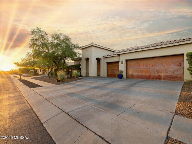3872 W Sonoma Ranch Pl, Marana, AZ 85658 - mediterranean / spanish-style home with driveway, a garage, stucco siding, and a tiled roof