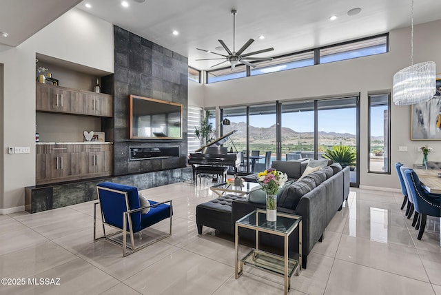 379 Camino A Las Casitas, Rio Rico, AZ 85648 - living area featuring ceiling fan, recessed lighting, a towering ceiling, light tile patterned floors, and a chandelier