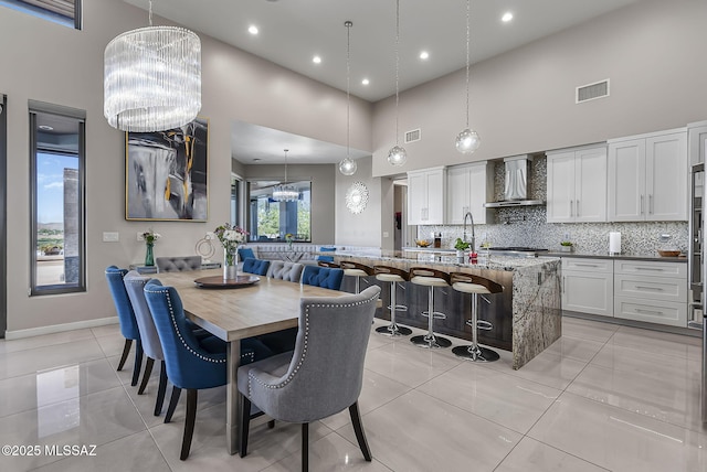 379 Camino A Las Casitas, Rio Rico, AZ 85648 - dining space with a high ceiling, a chandelier, light tile patterned floors, and recessed lighting
