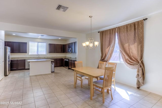 8348 N Mountain Stone Pine Way, Tucson, AZ 85743 - dining room with a chandelier and light tile patterned floors