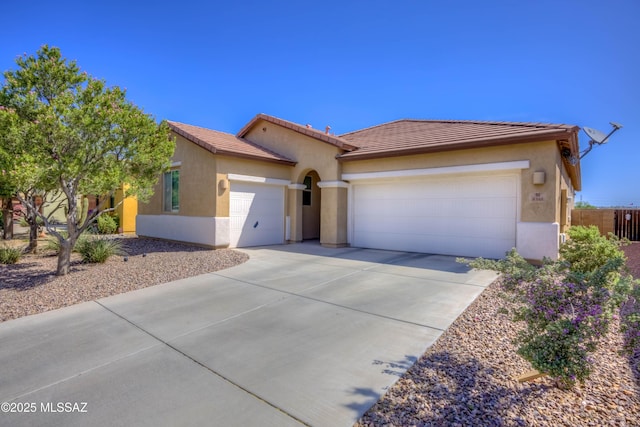 8348 N Mountain Stone Pine Way, Tucson, AZ 85743 - view of front of property featuring an attached garage, concrete driveway, stucco siding, and a tiled roof