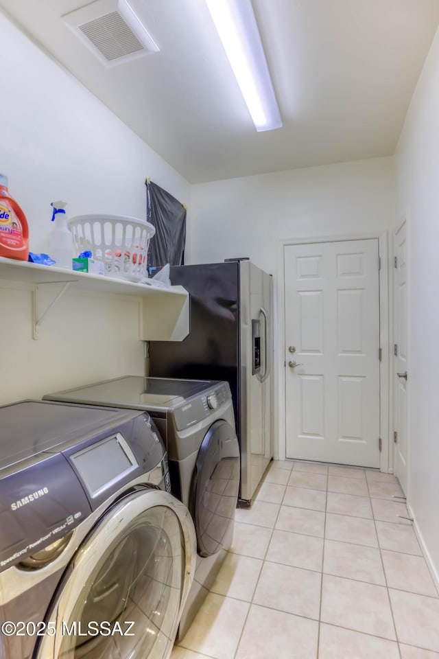 8348 N Mountain Stone Pine Way, Tucson, AZ 85743 - washroom with washer and clothes dryer and light tile patterned flooring