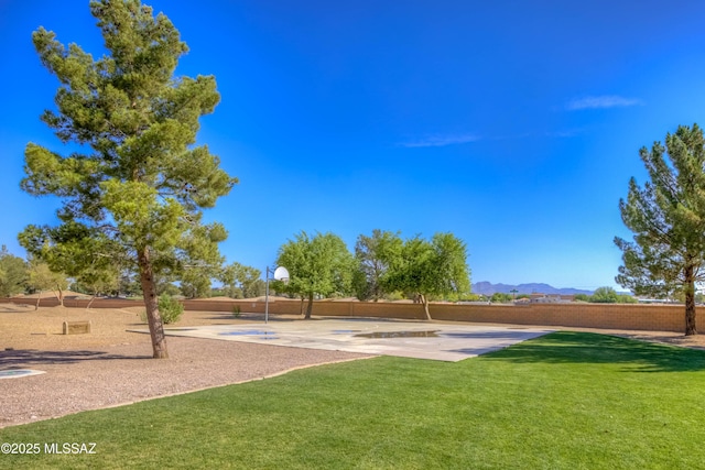 8348 N Mountain Stone Pine Way, Tucson, AZ 85743 - view of yard with basketball hoop and a mountain view