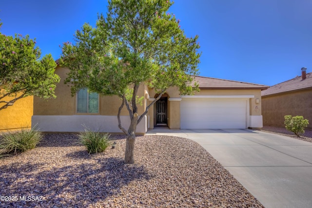 8348 N Mountain Stone Pine Way, Tucson, AZ 85743 - view of front of property featuring an attached garage, driveway, and stucco siding