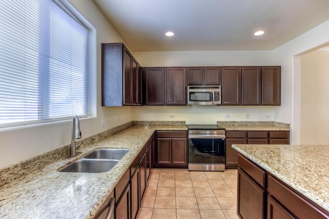 8348 N Mountain Stone Pine Way, Tucson, AZ 85743 - kitchen featuring appliances with stainless steel finishes, light stone countertops, dark brown cabinets, light tile patterned floors, and recessed lighting