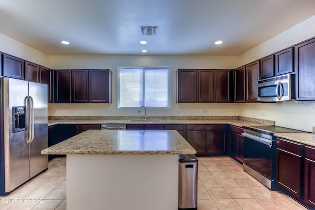 8348 N Mountain Stone Pine Way, Tucson, AZ 85743 - kitchen with stainless steel appliances, light tile patterned floors, a kitchen island, light stone counters, and recessed lighting