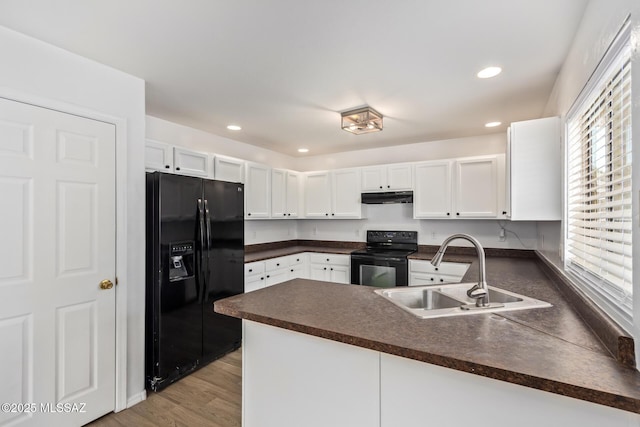3969 E Agate Knoll Dr, Tucson, AZ 85756 - kitchen with black appliances, dark countertops, a peninsula, white cabinets, and under cabinet range hood