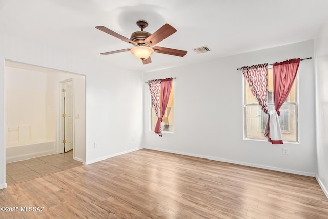 3969 E Agate Knoll Dr, Tucson, AZ 85756 - spare room featuring plenty of natural light, light wood-style floors, and a ceiling fan