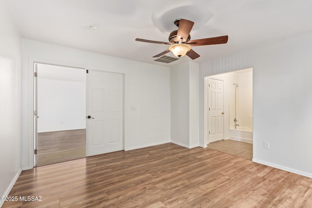 3969 E Agate Knoll Dr, Tucson, AZ 85756 - unfurnished bedroom featuring wood finished floors, a closet, ceiling fan, and connected bathroom