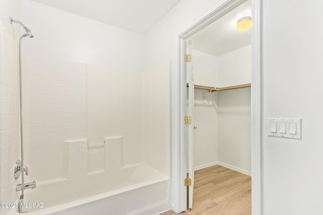 3969 E Agate Knoll Dr, Tucson, AZ 85756 - bathroom featuring wood finished floors, shower / washtub combination, and a spacious closet