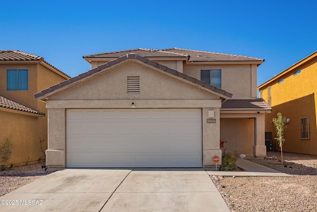 3969 E Agate Knoll Dr, Tucson, AZ 85756 - traditional-style home with driveway, an attached garage, stucco siding, and a tile roof