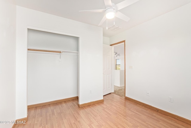 3969 E Agate Knoll Dr, Tucson, AZ 85756 - unfurnished bedroom featuring wood finished floors, a closet, and a ceiling fan