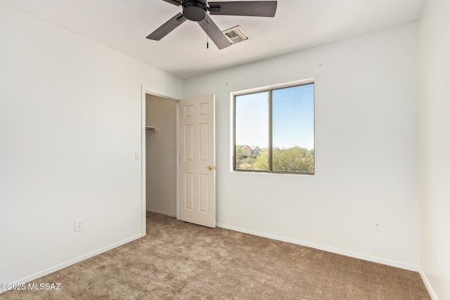 3969 E Agate Knoll Dr, Tucson, AZ 85756 - unfurnished bedroom featuring carpet, a walk in closet, and ceiling fan