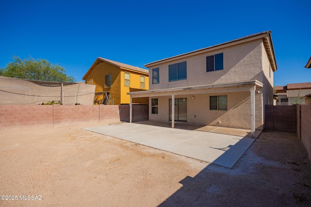 3969 E Agate Knoll Dr, Tucson, AZ 85756 - back of property with stucco siding, a fenced backyard, and a patio
