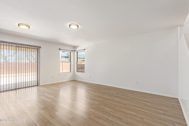 3969 E Agate Knoll Dr, Tucson, AZ 85756 - spare room with light wood-type flooring and baseboards