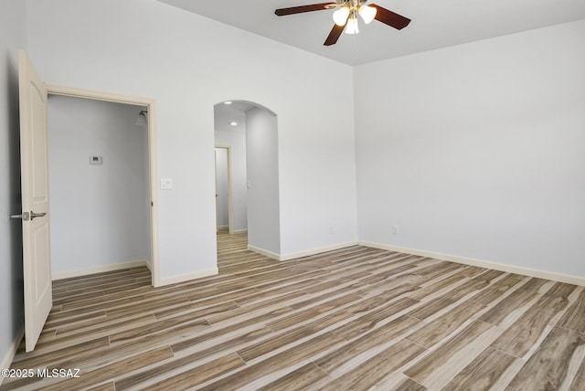 1793 Ariosto Ct, Rio Rico, AZ 85648 - unfurnished room featuring a ceiling fan, arched walkways, and light wood-style floors