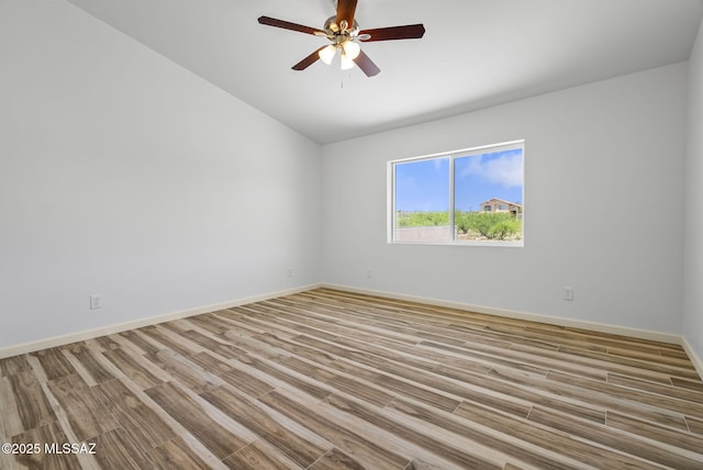 1793 Ariosto Ct, Rio Rico, AZ 85648 - unfurnished room featuring wood finished floors, vaulted ceiling, and a ceiling fan