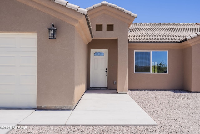 1793 Ariosto Ct, Rio Rico, AZ 85648 - doorway to property featuring stucco siding, an attached garage, and a tile roof