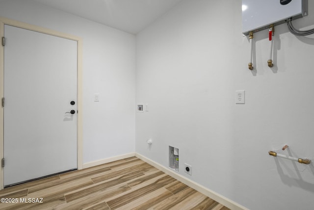 1793 Ariosto Ct, Rio Rico, AZ 85648 - washroom with hookup for a gas dryer, hookup for a washing machine, wood finished floors, and hookup for an electric dryer