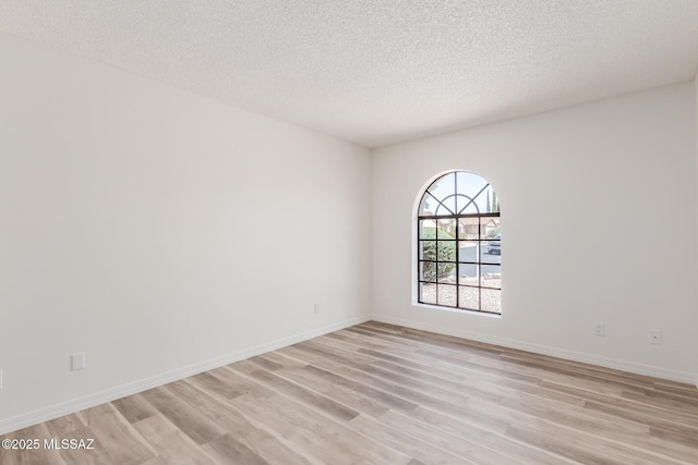 64161 E Santa Catalina Ct, Saddlebrooke, AZ 85739 - unfurnished room with light wood-style flooring and a textured ceiling