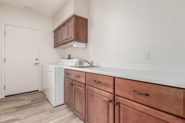 64161 E Santa Catalina Ct, Saddlebrooke, AZ 85739 - washroom featuring cabinet space, washer and dryer, and light wood-style floors