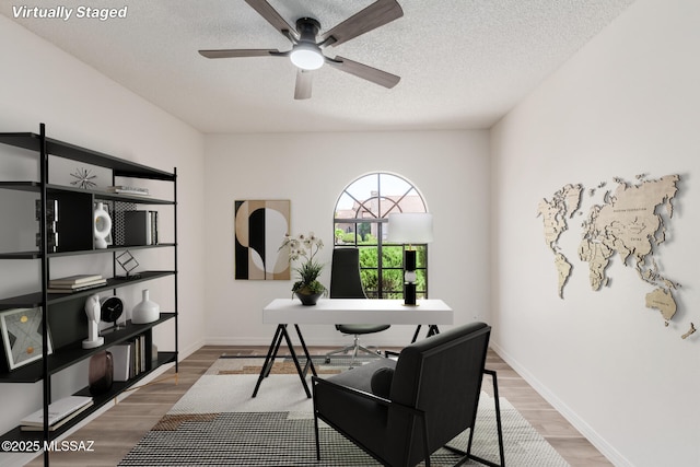 64161 E Santa Catalina Ct, Saddlebrooke, AZ 85739 - office area featuring a ceiling fan, wood finished floors, and a textured ceiling