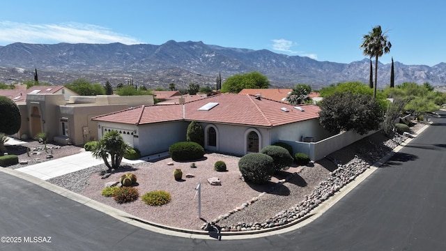 64161 E Santa Catalina Ct, Saddlebrooke, AZ 85739 - view of front of home with a garage, a mountain view, driveway, and stucco siding
