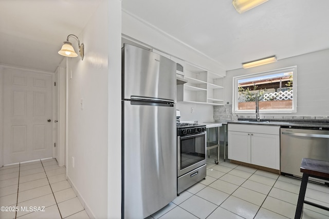 1818 E Mitchell St, Tucson, AZ 85719 - kitchen featuring stainless steel appliances, light tile patterned floors, white cabinetry, open shelves, and decorative backsplash