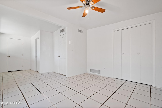1818 E Mitchell St, Tucson, AZ 85719 - unfurnished bedroom featuring a ceiling fan, a closet, and light tile patterned flooring