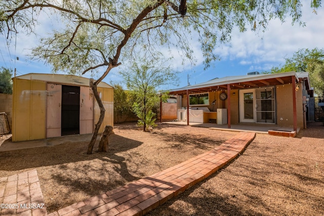 1818 E Mitchell St, Tucson, AZ 85719 - rear view of property with a shed and a patio